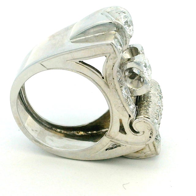 A striking vintage diamond ring crafted in platinum, dating to around the 1940s. The design is bold and architectural,...