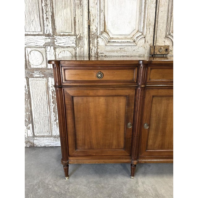 A louis xvi style cherrywood sideboard from the second half of the 20th century. Good condition, with its keys, three...