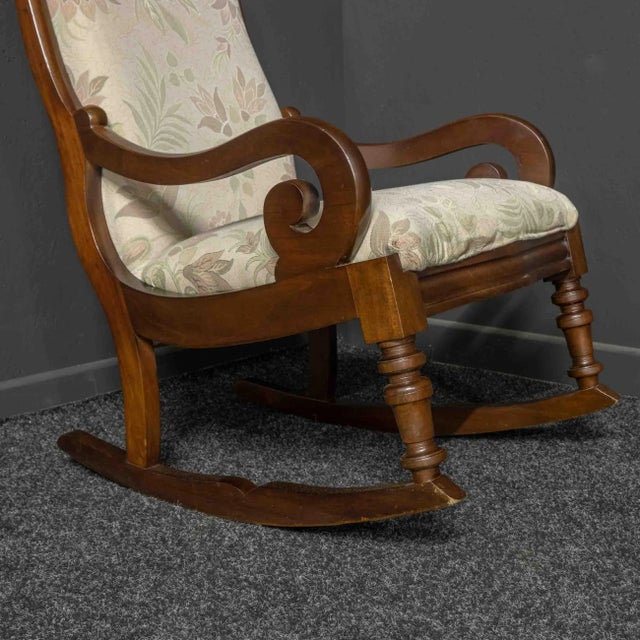 A good solid Victorian mahogany rocking chair. Re-polished and upholstered approximately ten years ago with the fabric...