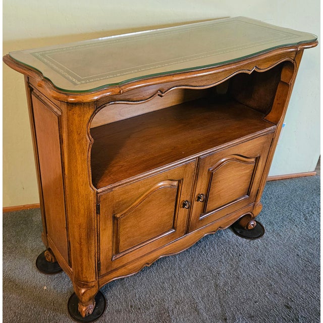This marvelous mid-century French country style hall or entry cabinet is created in gorgeous honey brown maple, The...