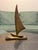 Beautiful vintage solid brass sailboat sculpture featuring an elegant, sweeping sail and sleek, minimalist design. This...