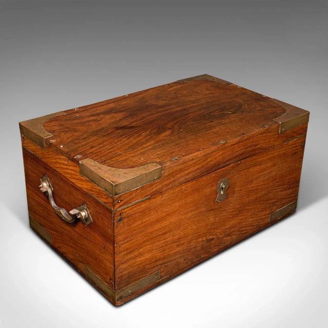 This is an antique campaign correspondence box. An Anglo-Indian, teak and brass bound Colonial traveller's writing case,...