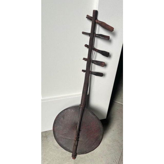 The Vintage African Antique Adungu 5 String Gourd Harp is a rare and handmade collectible from Kenya. This unique...