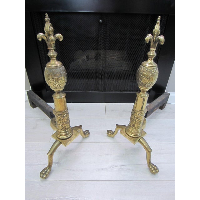 French brass andirons, decorated Fleur d' Elise finial, unique English claw foot paws. Iron bars. from Circa early 1900,...