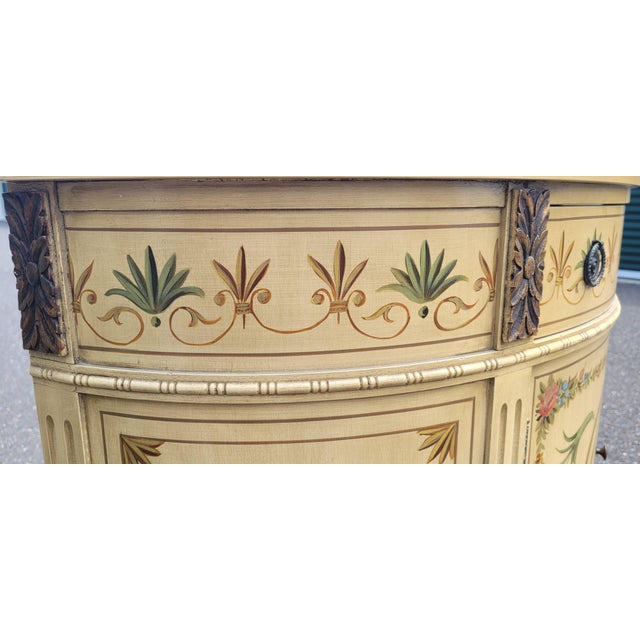 Beautiful antique Adams painted credenza. Features single drawer over a cabinet in a demilune form painted with flowers...