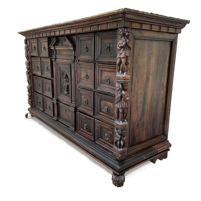 Antique Genoese coin cabinet from the 17th century, constructed with a walnut frame and poplar drawers veneered in walnut....