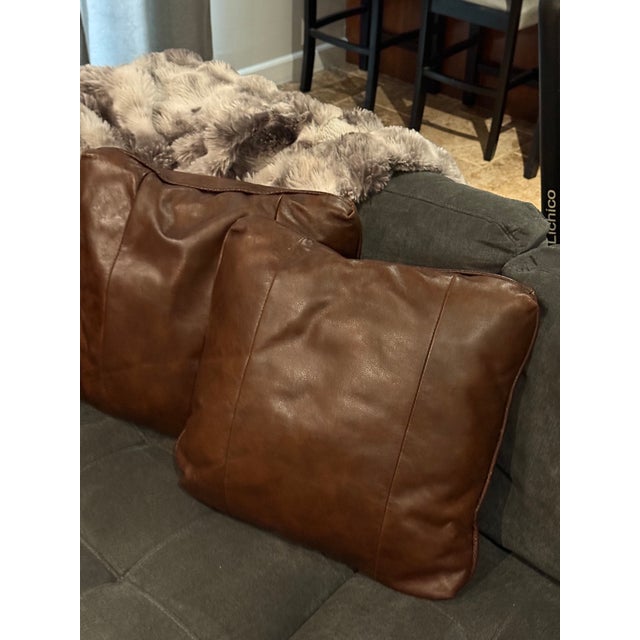 Beautiful pair of vintage leather throw pillows with a rich, warm brown finish that brings an instant sense of cozy,...