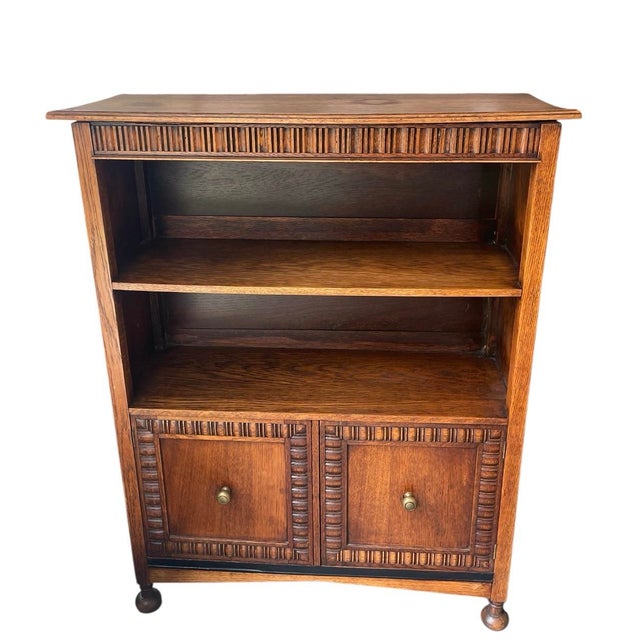 This charming vintage bookcase offers a perfect blend of open display and concealed storage. Crafted from solid oak with a...