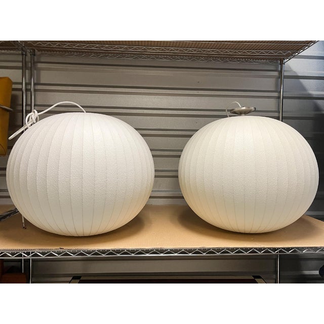 From the Nelson Bubble Pendant Lamp series, designed by George Nelson in the 1950s. These two globe pendants are crafted...