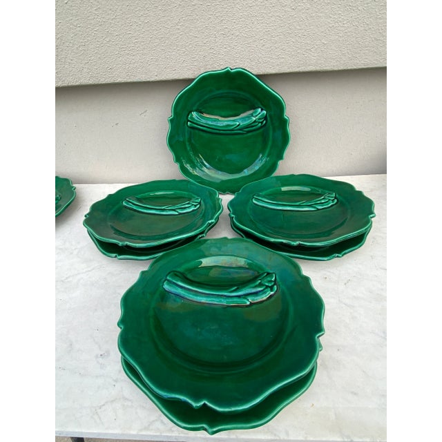 Green Majolica asparagus set signed Vallauris, circa 1950. Set of 12 plates and 1 platter Plate /9 inches diameter....