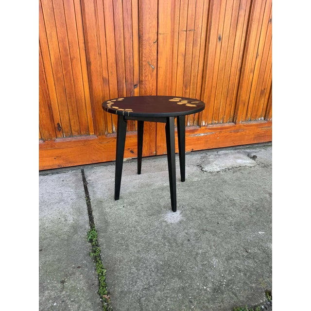Black side table. Small wood side table with 2 black hand-painted acryl layers. Decorated with Ginko Biloba leaves. Hand-...