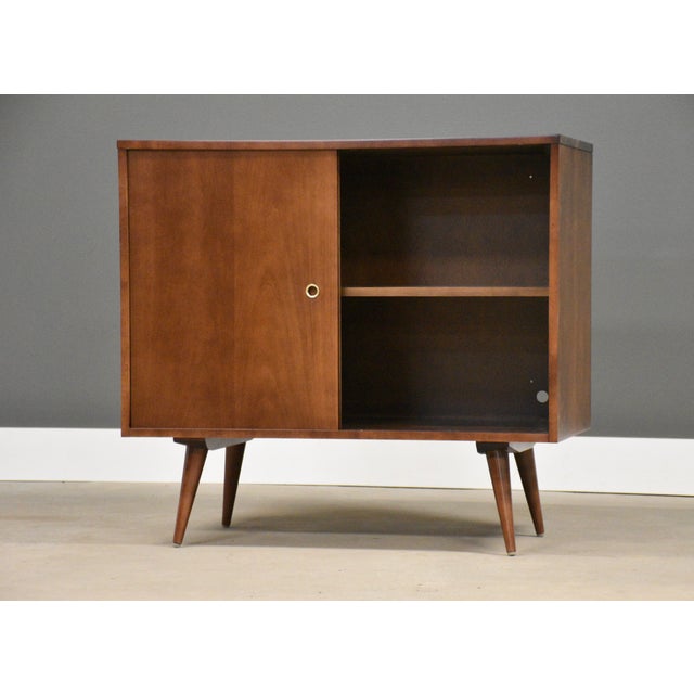 A mid century modern solid maple cabinet credenza designed by Paul McCobb for Winchendon’s Planner Group with two sliding...