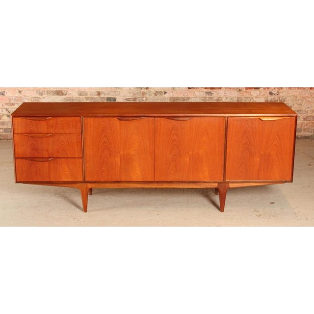 A mid century dunvegan teak sideboard designed by tom robertson and manufactured by a.h. Mcintosh of kirkcaldy, scotland,...