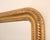 A Napoleon III Giltwood Mirror. Giltwood frame featuring fine carved details and rounded top corners.