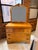 A beautifully crafted late 1930s Art Deco dresser with its original matching mirror, distinguished by book-matched...