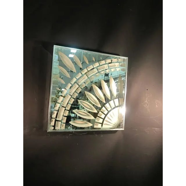 An exceptional modern chrome and glass wall mirror with unusual design by Greg Copeland, dated 1973. Good condition.