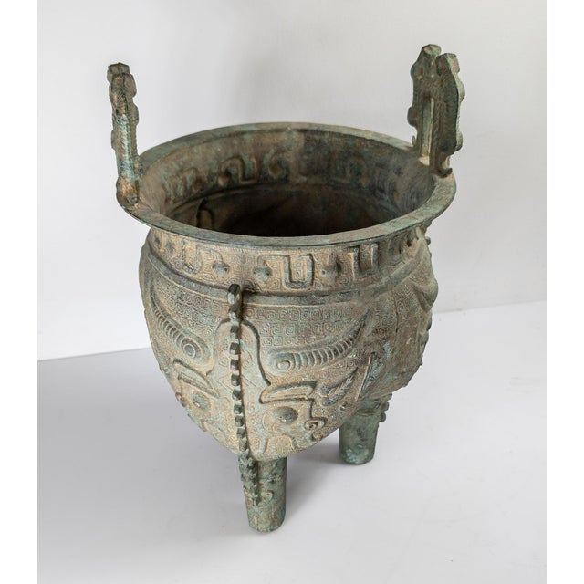 We are selling this large Chinese style verdigris brass Ding vase. This vase is cast in the Shang style with Taotie...