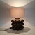 The Porta Romana table lamp captivates with its textured surface of glazed ceramic in a deep brown tone. Height: 33.5 cm...