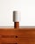 Cylindrical teak base with a white lacquered metal shade featuring overlapping geometric openings. Designed by Hans-Agne...