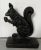 Art Deco cast iron squirrel door stop. Highly stylized squirrel in profile clutching an acorn. Measures 7 1/4" tall x 5...