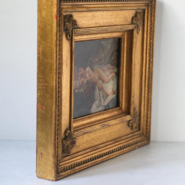 Oil painting on board depicting a reclining nude woman with a book in an interior setting. The composition is rendered in...