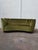 : Banana curved sofa with an elegant design and green velvet upholstery, Denmark, 1980s. – Wooden legs. – Button-tufted...
