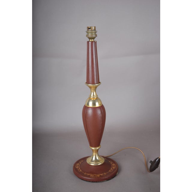 1950s table lamp in the French leather-house tradition, with a baluster body and tapering upper stem covered in stitched...