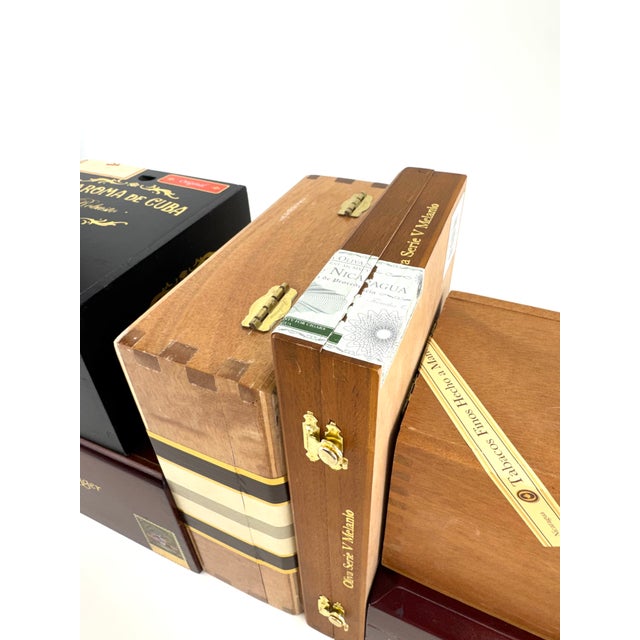 A curated collection of six premium wooden cigar boxes from Perdomo, Oliva, La Flor Dominicana, and La Aroma de Cuba,...