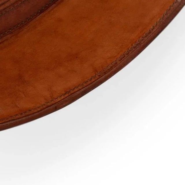 The round cognac color leather wrapped mirror has a fun leather hanger. This mirror design was inspired for a masculine...