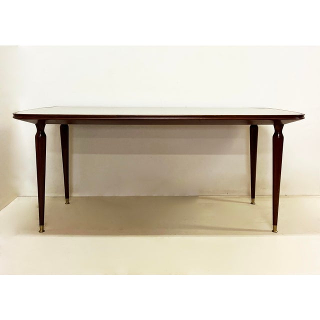 Rectangular deco dining table, entirely in wood with painted glass top and beveled corners. Period: 1930 Origin: Italy...
