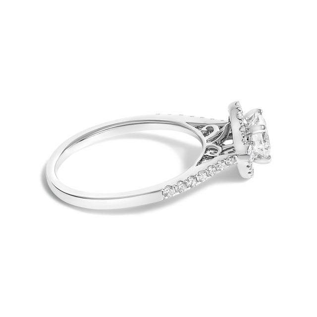 Crafted from the pristine elegance of 14K white gold, this enchanting engagement ring is a testament to love's pure...