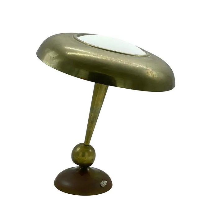 This vintage Italian table lamp is made of brass and glass. It has an adjustable arm. Brass table lamp designed by Oscar...