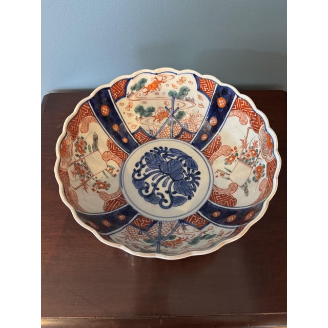 Beautiful hand-painted Imari porcelain bowl with an elegant scalloped rim. The bowl is richly decorated in the...