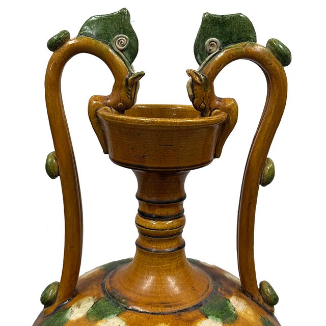 This vessel is a classic example of a Chinese Sancai-glazed double dragon-handled amphora. It is a high-quality...