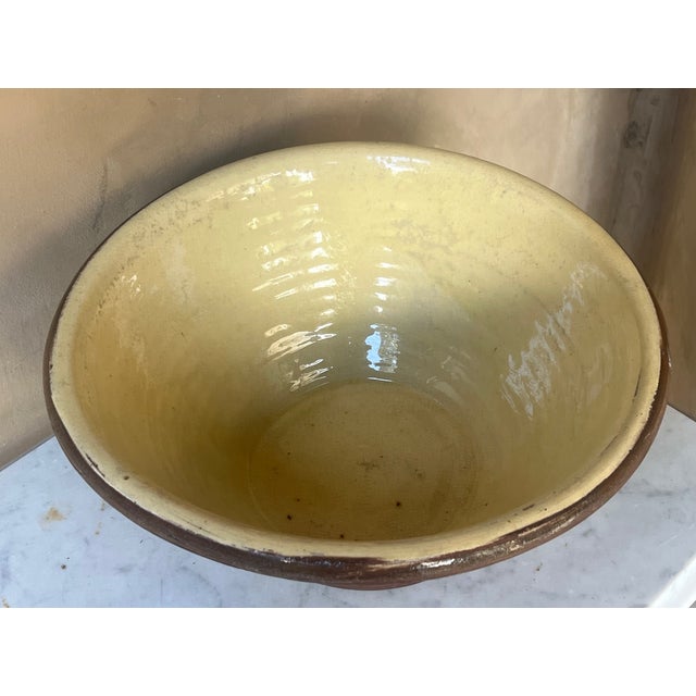 Large terracotta and yellow glazed pancheon bowl used for mixing dough or standing milk, made in France in the late 19th...