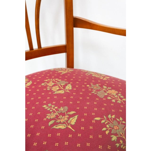 Chair with armrests of excellent workmanship by Selva In classic style with padded seat and burgundy flowered fabric...