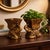 A sculptural pair of Hollywood Regency elephant cachepots with rich antiqued gold finish and ornate detailing. Perfect for...