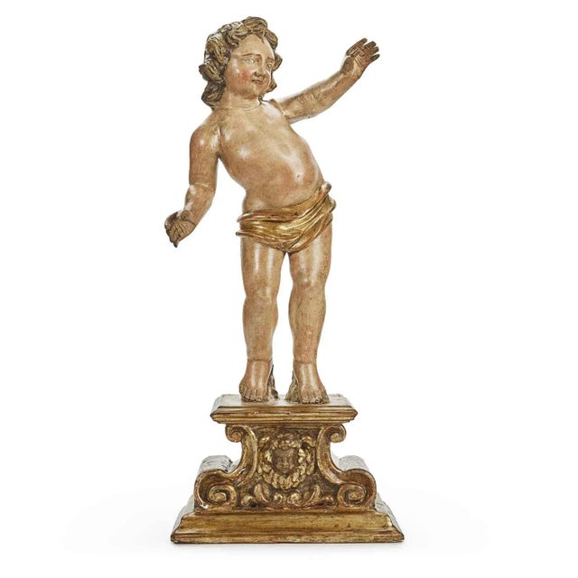 A pair of figures on a carved base from 1700. They are two naked cherubs covered only by golden loincloths; apparently two...