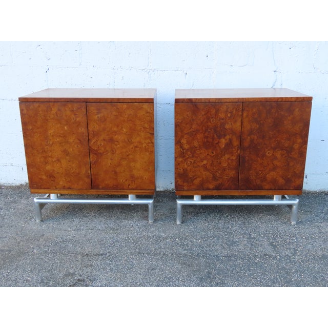 This Pair of Nightstands is made of wood, solid wood, burlwood, veneer, and metal. The Nightstands were made by White...