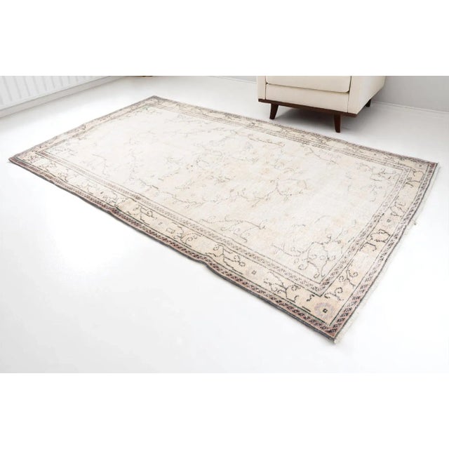 This is a vintage Turkish Oushak rug from the 1960s. The piece was hand-knotted.