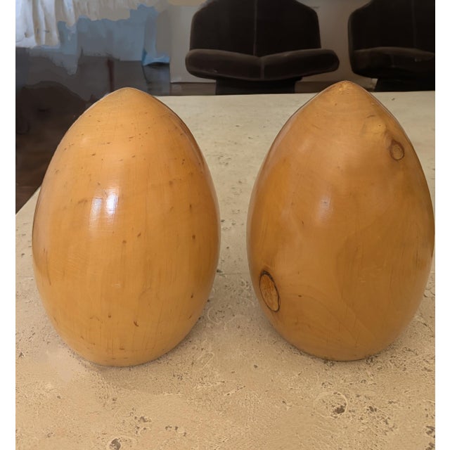 Two large burled wood egg shaped polished sculptures and smooth to the touch. So many variations in the wood grain...