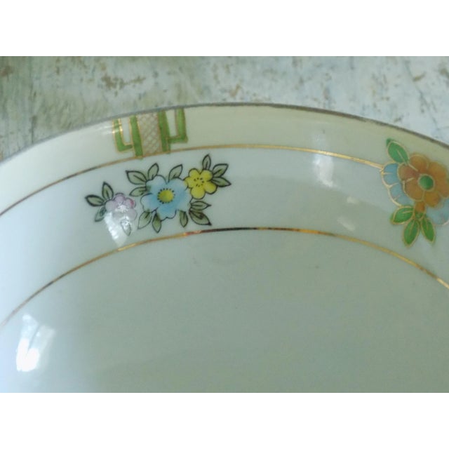 Lovely Meito China floral pattern Nippon Eral finger bowl with three round gold feet. This sweet little bowl dates...