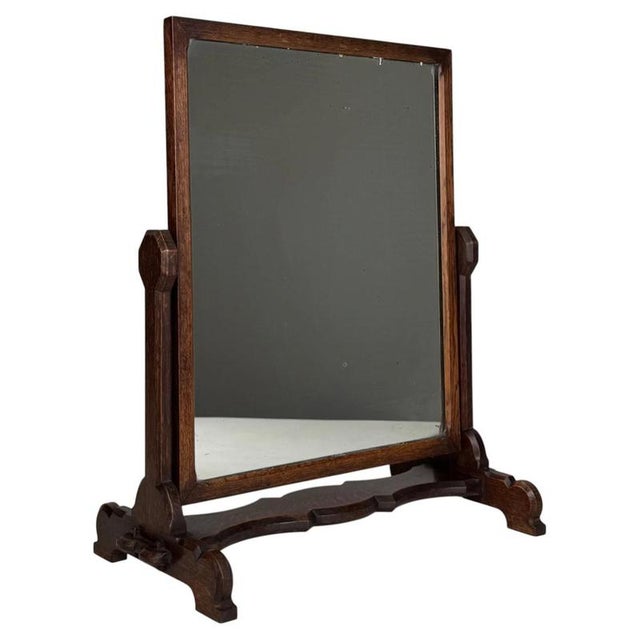 A charming and beautifully crafted 20th-century dressing mirror, constructed in oak and distinguished by its Arts and...