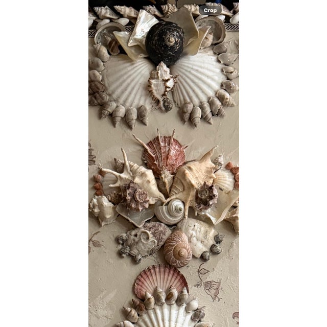 Wall panel embellished with shells and hand painted elements, on a textured base. Patina applied to replicate age.