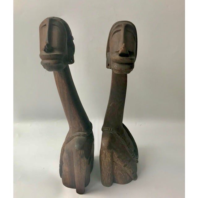 Spectacular mid-century African carved sculptures of man and woman. Circa 1950s. Solid wood. Bottoms are marked with a 1...