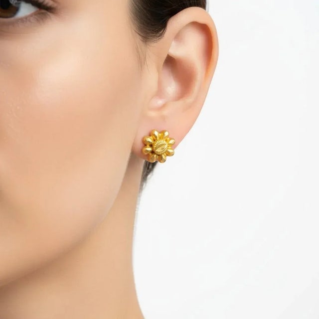 A refined symbol of heritage and craftsmanship, this pair of 22k Yellow Gold Floral Stud Earrings represents the pinnacle...