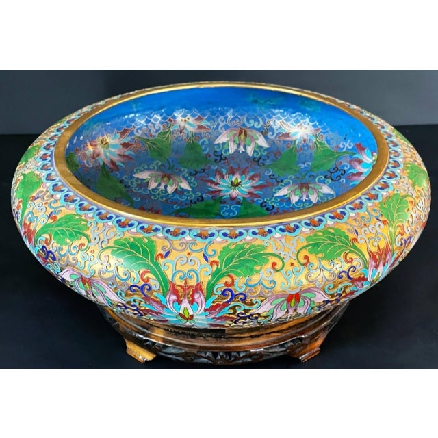 A large Chinese cloisonné bowl, about 14 inches across, covered in lotus blossoms and scrolling leaves in turquoise,...