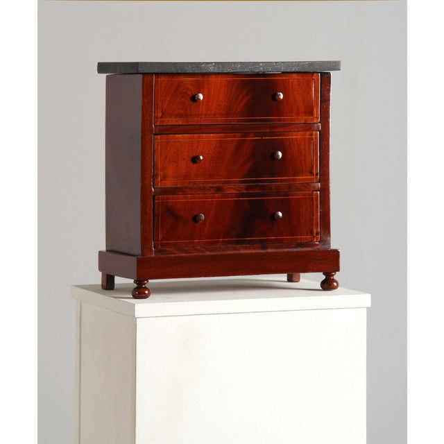 Miniature Chest of Drawers with Marble Top Origin: Central Europe Material: Mahogany, maple Date: 19th century Dimensions:...