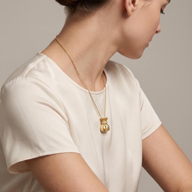 Elevate your jewelry collection with our exquisite Vintage Money Bag Charm, crafted from luxurious 18k yellow gold and...
