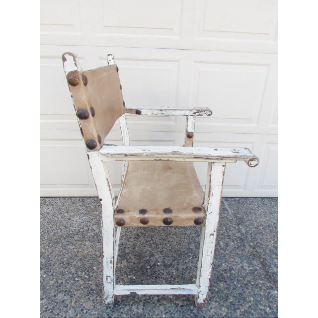 Rustic antique painted Spanish armchair, c.1830 Made of a rustic walnut frame with light tan leather upholstery to the...